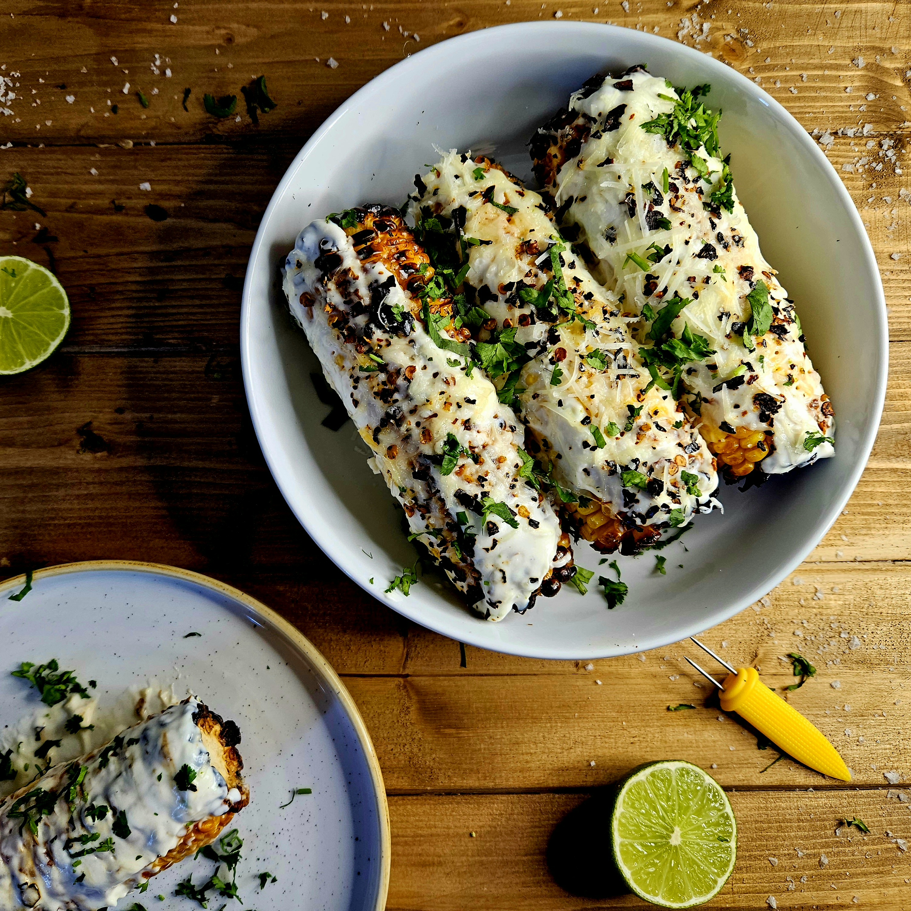 Elotes (Mexican Street Corn) with SOur Cream, Mayo, Ancho Chilli Flakes, Parmesan repalcing Cojito Cheese